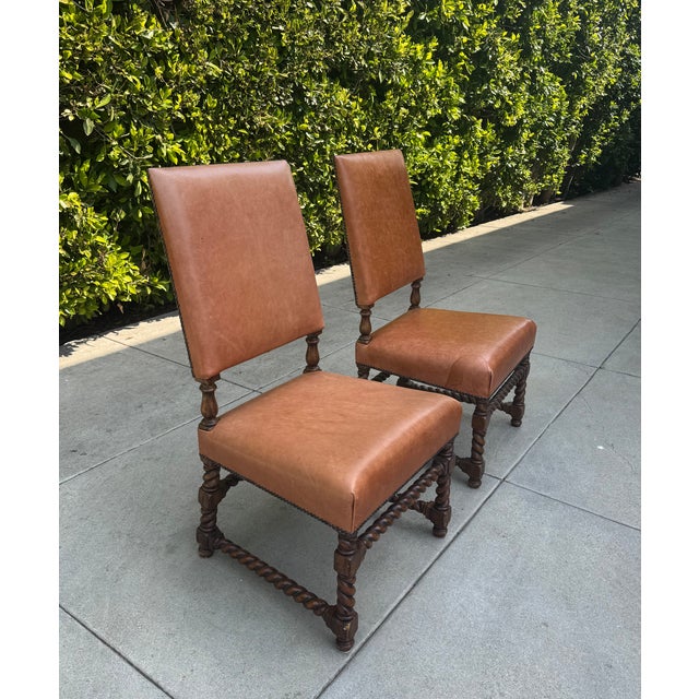 Beautiful pair of vintage, leather upholstered side chairs with gorgeous handcrafted brass nailhead trim. Fine saddle...