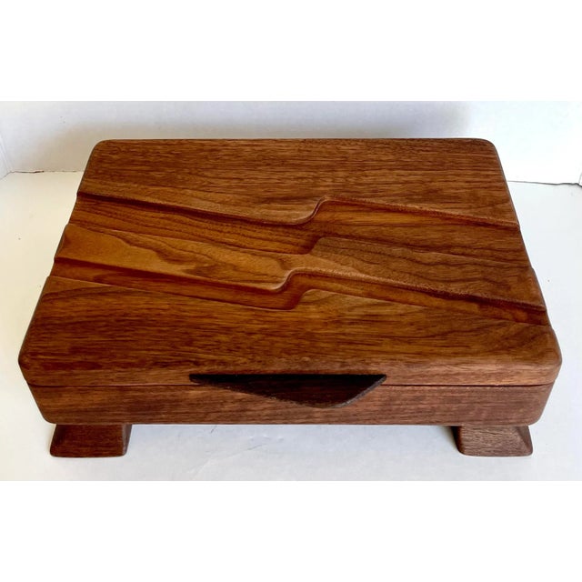Here is a stunning piece of functional art! It is a hand-made, hand carved box that is lined in a caramel suede for your...