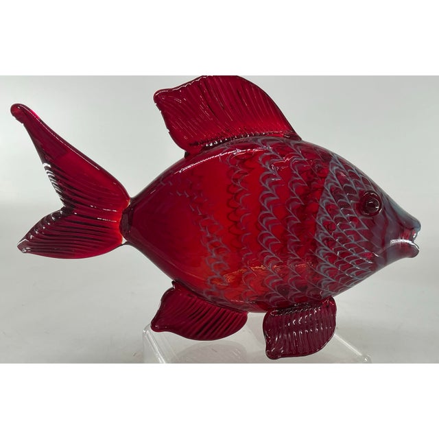 Beautiful ruby red glass fifth by American glass blower Chris Belleau. Etched signature on the bottom. Textured “scales”...