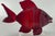 Beautiful ruby red glass fifth by American glass blower Chris Belleau. Etched signature on the bottom. Textured “scales”...