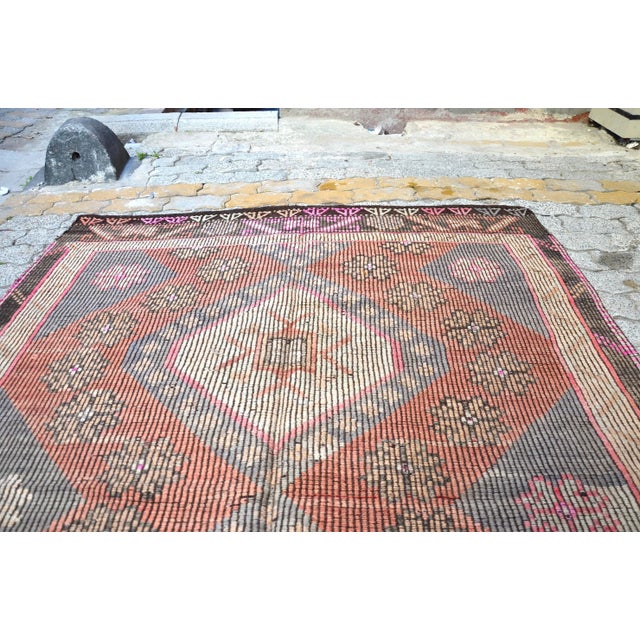 This is a vintage Turkish Anatolian kilim rug from the 1960s. The piece was hand-woven.