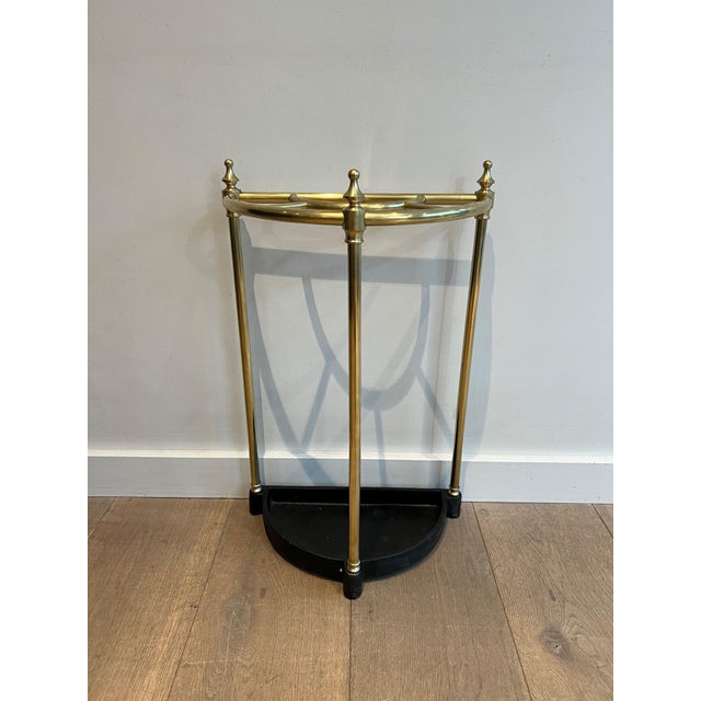 This nice rounded umbrella stand is made of brass and cast iron. This is a French work. Circa 1900