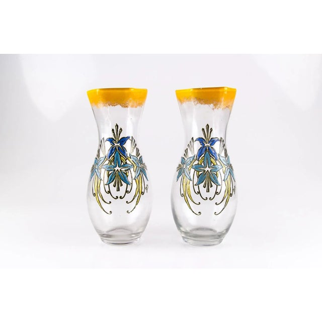 - An elegant pair of French Art Nouveau glass vases. - Enameled floral pattern in blue and gold colors. - Signed ''Leg.''...