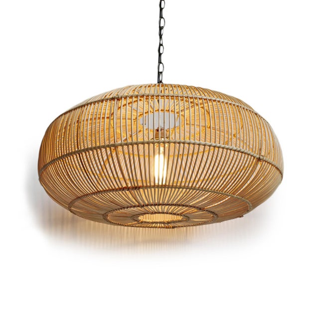 Handwoven pendant light made from finely split rattan with a low-profile silhouette that feels both airy and...