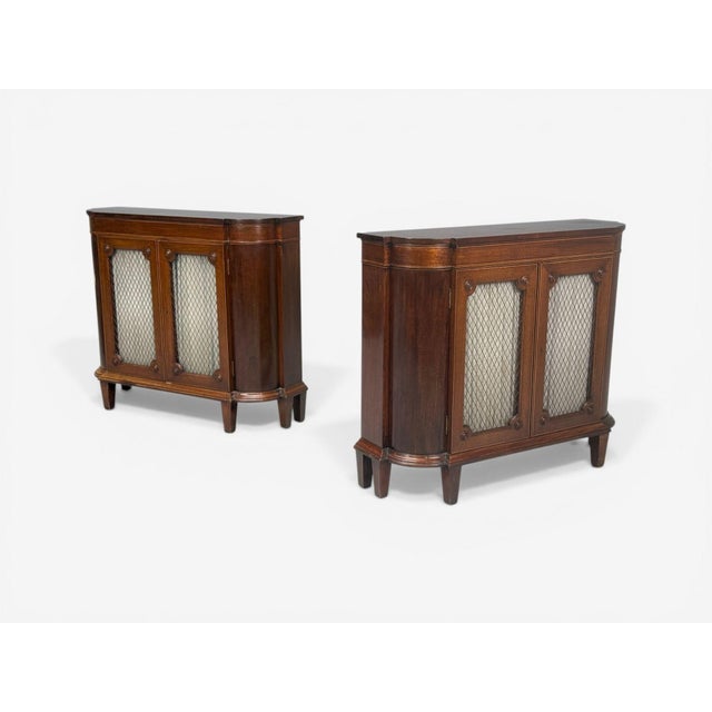 English Regency, Demilune Cabinets, Mahogany, Brass, Fabric, England, 20th c. Pair of narrow English Regency style...