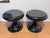 A striking pair of Space Age pedestal stools in glossy black fiberglass, embodying the bold sculptural language of...