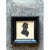 This vintage miniature portrait is a crisp profile silhouette of a figure facing right, cut in solid matte black paper and...