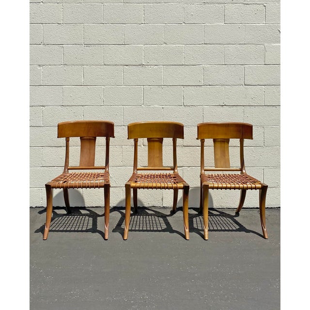A set of three beautiful leather rope klismos dining chairs by Kreiss. One is a slightly different hue than the other two,...