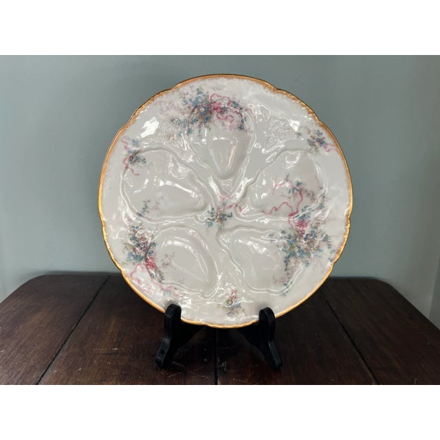 Antique Haviland Limoges porcelain oyster plate with painted floral and ribbon design
