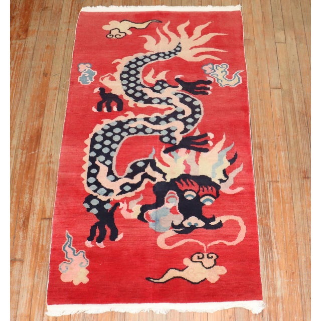 A colorful one-of-a-kind Tibetan rug from the 3rd quarter of the 20th century with a dragon motif on red ground Measures:...