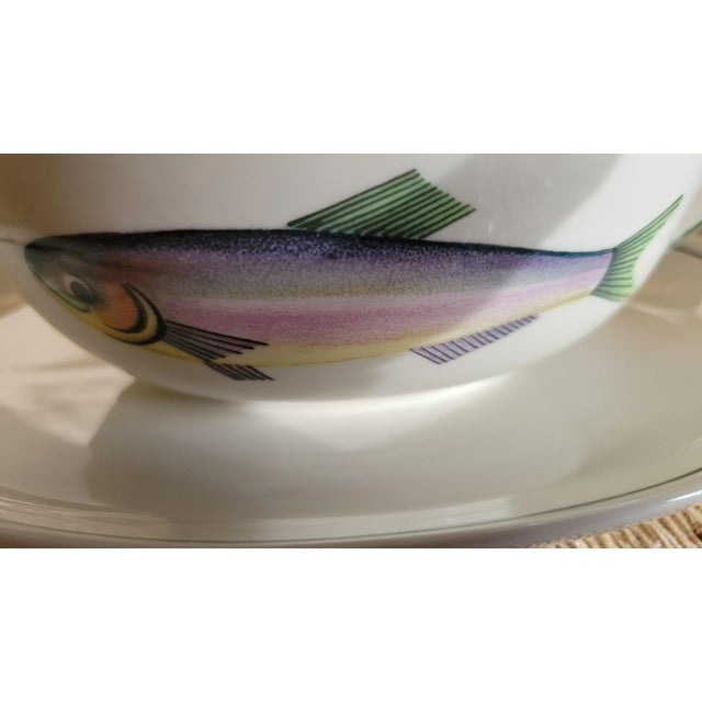 A delightful fusion of function and folk art, this vintage ceramic gravy boat and matching saucer bring playful elegance...