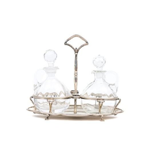 Italian two bottle cruet stand. Cut crystal bottles, stoppers fit into round holders on stand when cruet in use. Paw feet....