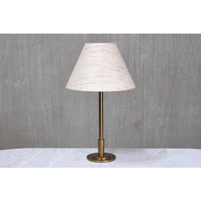 This rare table lamp was produced in Denmark in the 1950s and exemplifies the understated elegance of mid-century Danish...