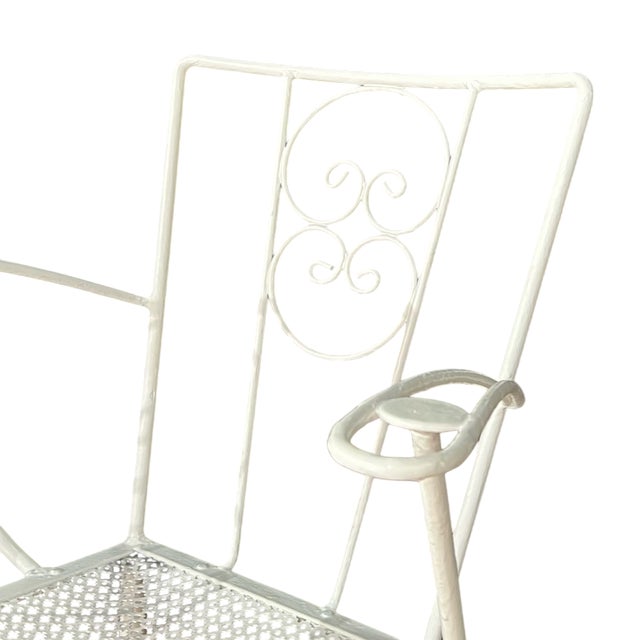 Wrought iron garden chairs painted white.