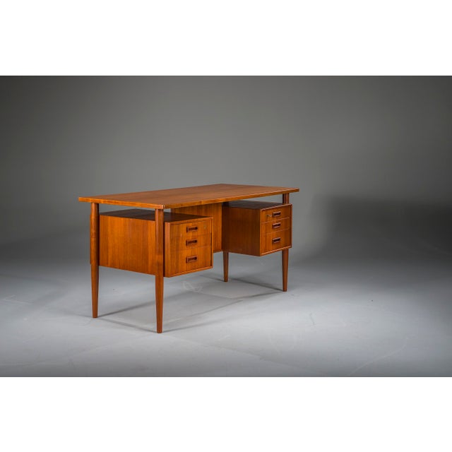 Exceptional Danish Modern desk in teak, produced in Denmark in the 1950s and attributed to a Danish designer. The desk...