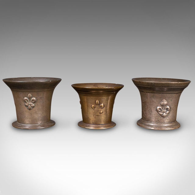 This is a trio of antique mortars. An English, bronze apothecary instrument, dating to the William III period, circa 1700....