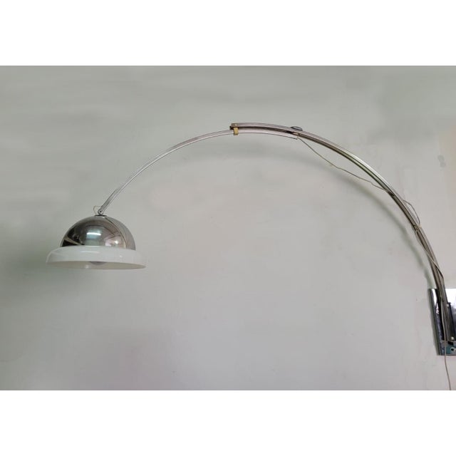 Telescopic wall lamp from the 1970s designed by goffredo reggiani for reggiani. Crafted from chromed steel with an opal...