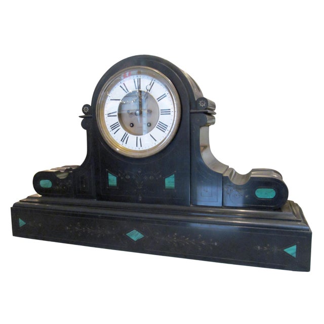 1860s Victorian black slate mantel clock in Brocot & Delettrez style. It is intricately carved with malachite stone...