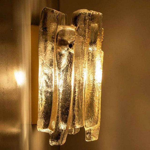 Beautiful and elegant modern wall lights in the style of kalmar in the 1970s. A lovely design. Nine thick, textured glass...