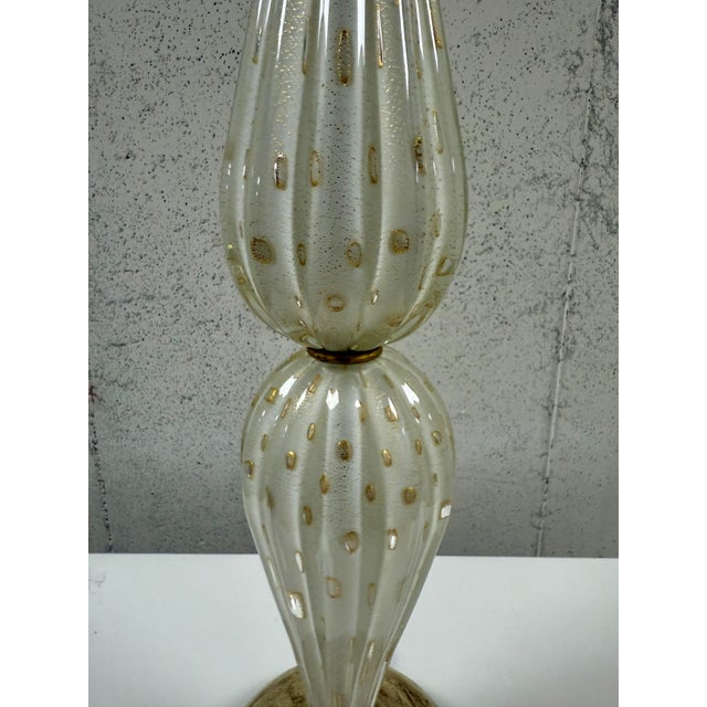 An elegant Italian Mid-Century Hand Blown Clear and Gold Murano / Venetian Glass Table Lamp. Made by the venerable...