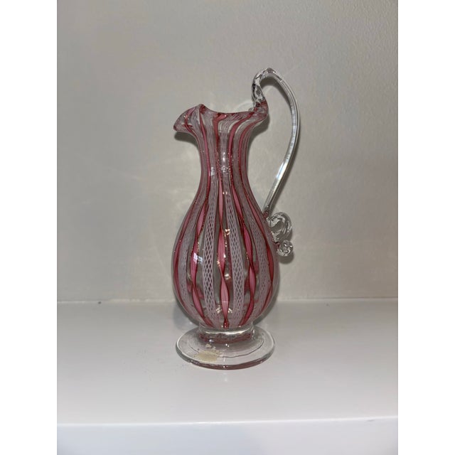An exquisite pair of mid-20th-century Venetian art glass, showcasing the pinnacle of Murano hand-blown craftsmanship. This...
