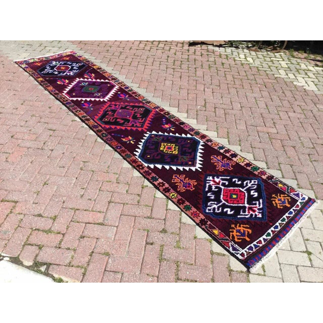 This gorgeous hand knotted vintage Anatolian runner rug is approximately 70 years old in excellent vintage condition. The...