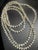 This long (62 inch) fluted necklace features transparent, mold-pressed glass bellflower (or trumpet flower) beads...