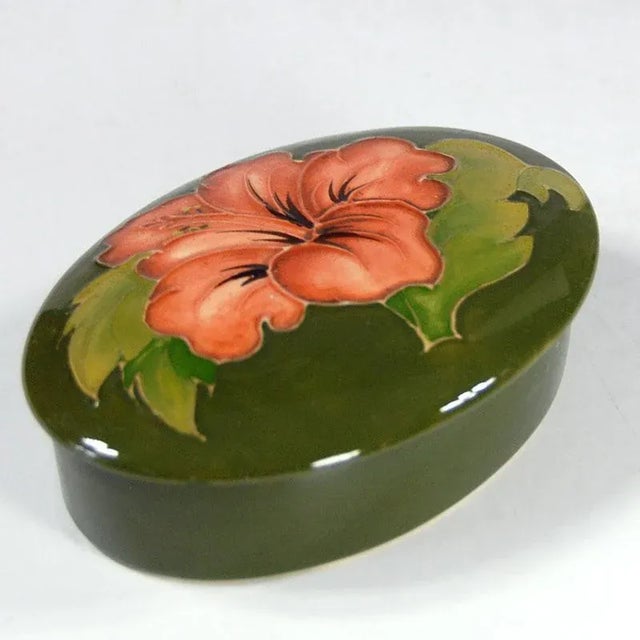 Ceramic, hand-decorated and glazed with a large gloss container with a lid. Decoration called Hibiscus. Preserved in very...