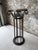 Striking vintage pedestal column featuring an ornate hand-forged iron base and sculptural marble top. The elegant...