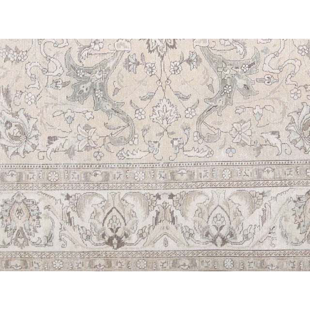 Expertly crafted in the traditional Tabriz style, this Semi Antique Persian Rug is a true work of art. Measuring 9'9" x...