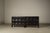 A brutalist four-door sideboard designed by jean batenburg for mi, belgium, during the 1960s, executed in solid ebonized...