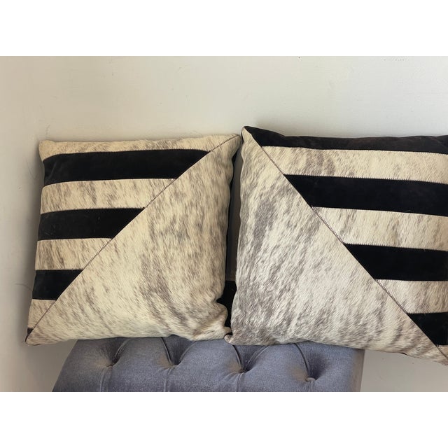 Gorgeous pair of cow hide ( or deer fur) leather pillows with brown leather back. Elegant geometric design.