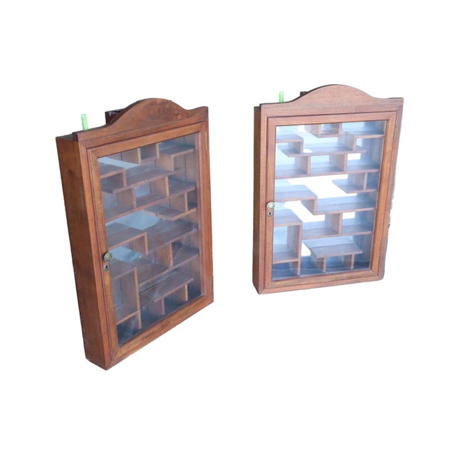 Pair of large hanging show cases with glass doors. The inside compartment, which is completely visible through the glass...