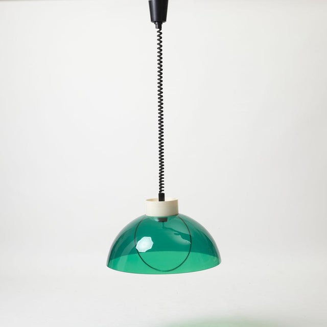 Beautiful adjustable space age pendant lamp produced by polam, poland, 1970s. 2 piece of clear green and white plastic....