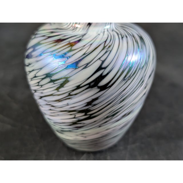 Gorgeous handmade iridescent glass vase. Very small, only three inches tall. There is one tiny chip on the fragile edge on...