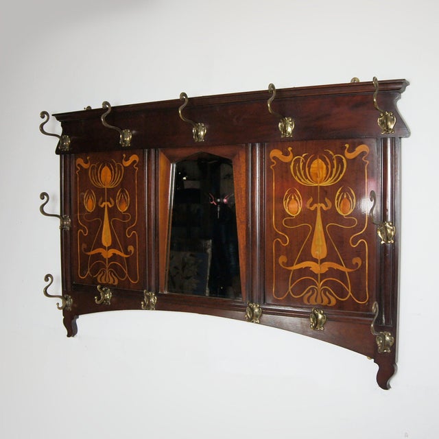 An Arts & Crafts Hat and Coat Stand by Shapland & Petter. Mahogoany with satinwood inlay and original bevelled mirror....
