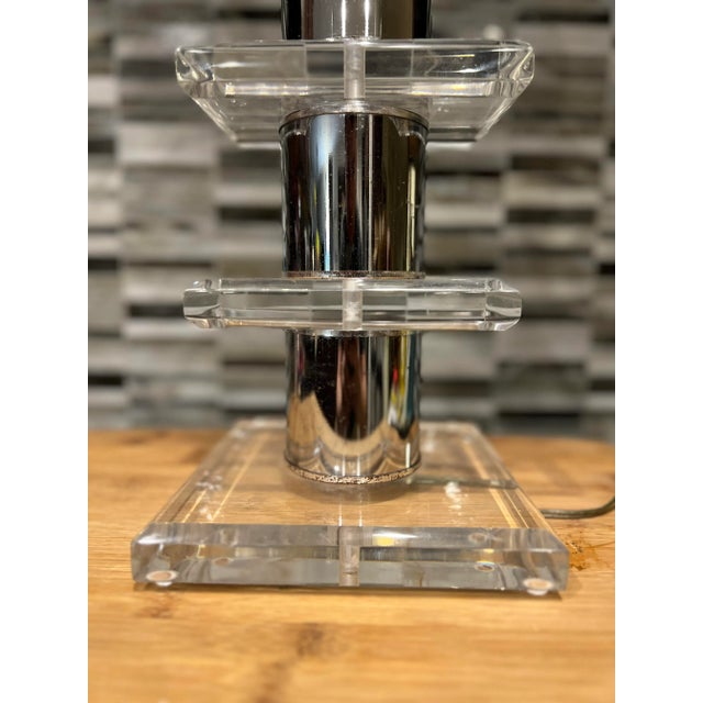 American, mid 20th century. A vintage MCM table lamp with stacked and tiered lucite blocks separated by chrome cylinders....