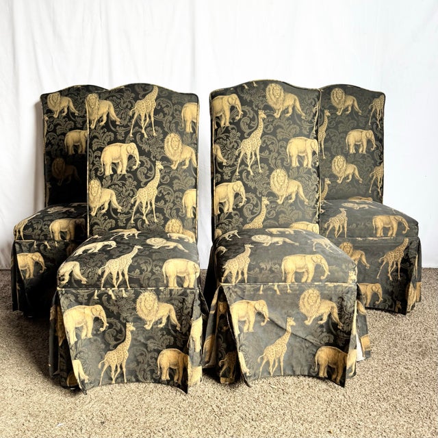 This set of four Vintage Regency Black and Gold Animals Skirted Parsons Dining Chairs brings theatrical elegance and...