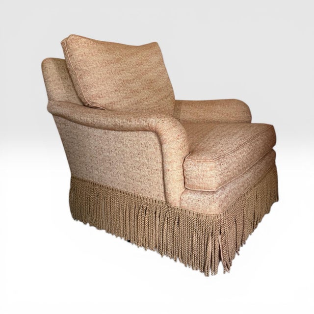 Swivel chair from Baker Furniture. The Simmons chair features classic rolled arms with an overstuffed back and seat...