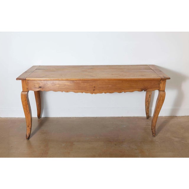 This 19th-century French farm table is a charming example of rustic craftsmanship and practicality. Constructed from...