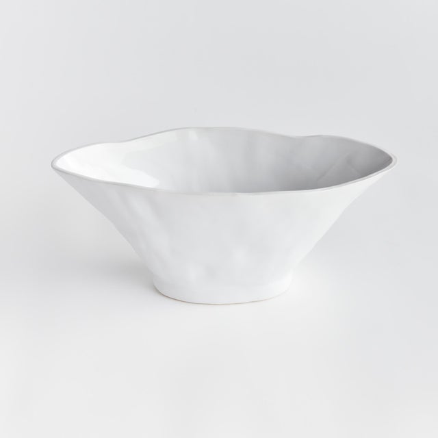 With a sculptural form and slim profile, this vase is made for narrow console or mantle. Drape a faux stem or two along...