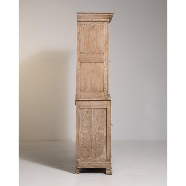 A Provençal vitrine reflecting the rustic elegance of southern French furniture, combining display shelving with enclosed...