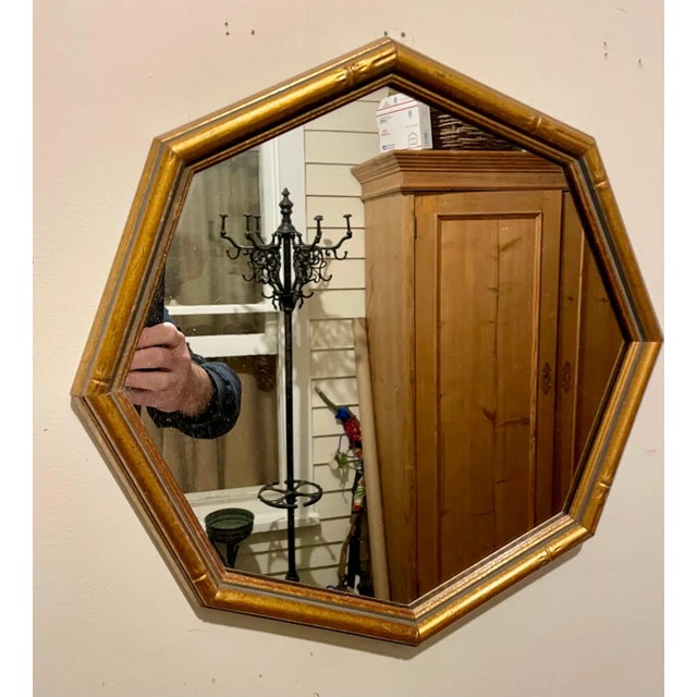 Large Gilt octagon Faux bamboo mirror. Measures 17.75" high x 17.75" wide x 1" deep. Two hooks on back for hanging two...