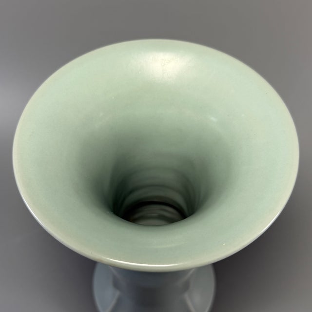 This elegant antique Gu vase (flower gu) is crafted in classic Chinese Longquan celadon style. It has a wide flared mouth,...