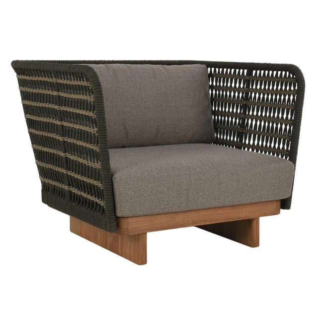 Modern outdoor easy chair with teak base/legs and woven charcoal and tan poly rope high arms and back. Grey polyester seat...