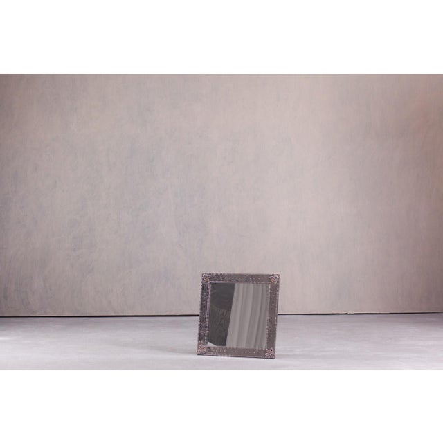 This vintage grimo wall mirror was produced by ikea in sweden during the 1990s. Its square frame features subtle blue and...