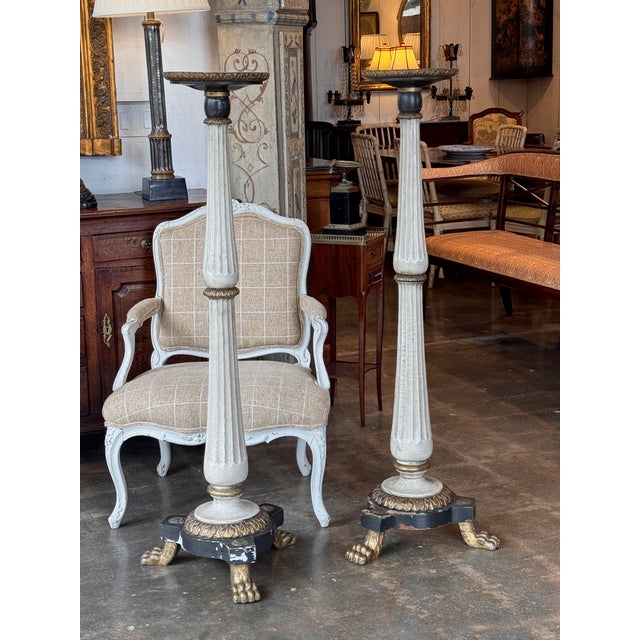 Neoclassical pedestals with circular tops over fluted tapering columns, set on circular bases with applied rosettes and...
