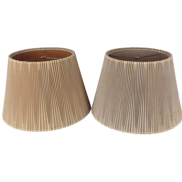 A pair of inverted knife-pleated fabric lamp shades by Stiffel, dating to the mid-20th century. Bottom opening is 17" Top...