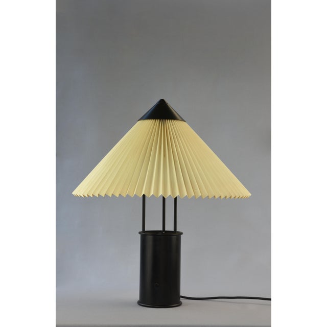 A distinctive Le Klint Model 389 uplighter, combining a black lacquered metal structure with an original vertically...