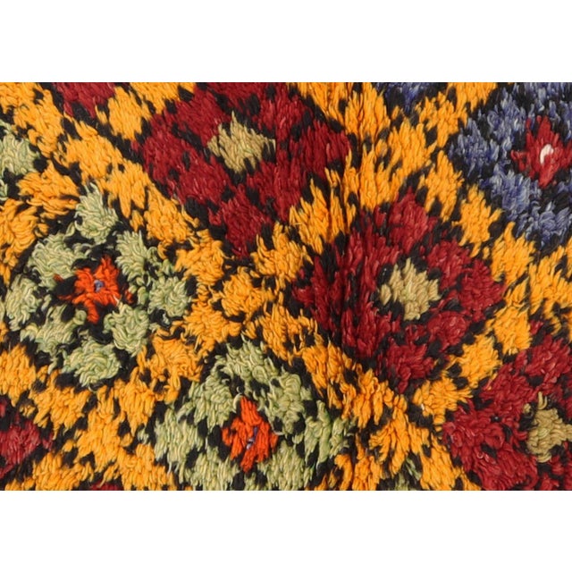 Expertly handwoven in the Konya region of Central Turkey, this 2'7" x 4'1" Vintage Turkish Tulu Rug showcases a unique...